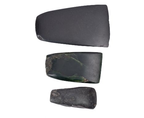 Three polished stone axe heads, possibly Neolithic, the largest 13cm high, 7.5cm wide