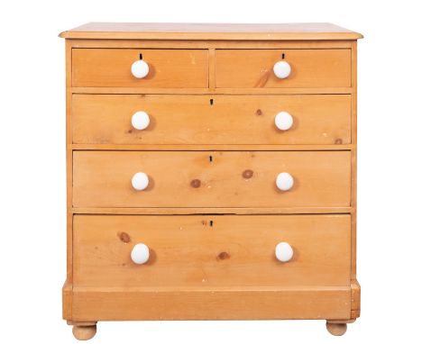 An Edwardian pine chest of drawers, early 20th century; the top with moulded edges; above two short and three graduated long 