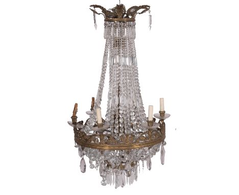 A gilt metal and cut glass hung sixteen light electrolier in Regency style, early 20th century; the hanging ring within a cir