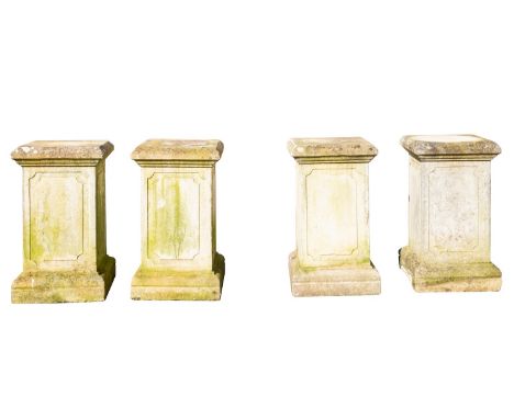 A set of four stone composition garden plinths, 20th century; of square section, each with panel moulded sides and ovolo moul