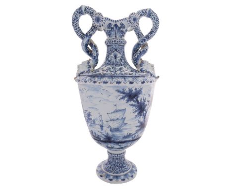 A large Dutch Delft pedestal vase with entwined serpent handles terminating in grotesque masks, painted in blue with a scene 