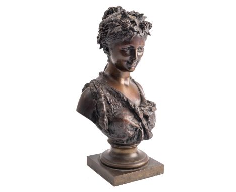 After Jean Bulio (French, 1827-1911), a patinated bronze bust of a Bacchante, circa 1900; portrayed smiling and looking strai