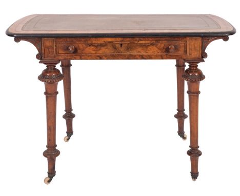 A Victorian walnut and line inlaid writing table, circa 1875; the rectangular top with slightly bowed ends enclosing an inset