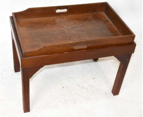 A mahogany butler's tray on associated stand terminating on block supports, width 73cm.