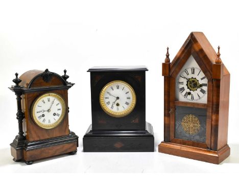 A late 19th century walnut and ebonised eight day mantel clock, with enamel Roman numeral dial and movement striking on a bel