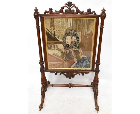A Victorian walnut framed firescreen, inset with tapestry panel on swept feet, height 116c, width 67cm.