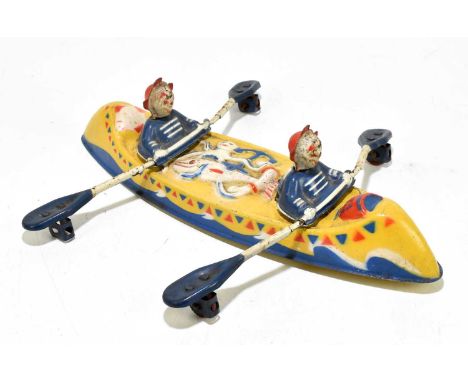 A vintage English made tinplate canoe, modelled with two clowns rowing, length 39cm.