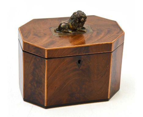A 19th century mahogany tea caddy with satinwood crossbanded detail, the cover with applied finial representing a lying spani