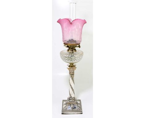 A 19th century silver plated oil lamp with etched cranberry shade and decorated with thistles above the cut glass reservoir, 