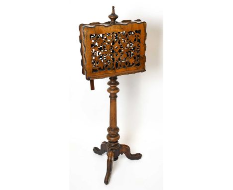 A Victorian walnut duet music stand, with serpentine and pierced music rests, on turned column and tripod base, height 129cm.