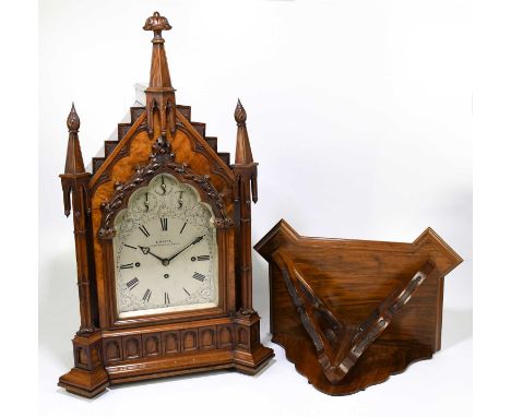 E. WHITE, 20 COCKSPUR STREET, LONDON; a 19th century Gothic Revival carved walnut cased bracket clock, with carved finials ab