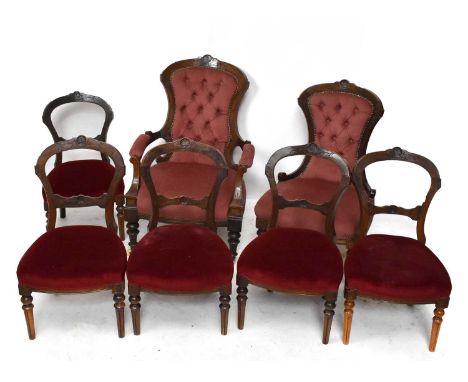 Two late Victorian carved walnut show frame salon chairs with button back upholstery on turned legs, with five salon chairs (
