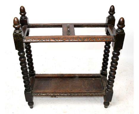 A late 19th century carved oak two division stick stand, width 60cm, depth 24cm, 70cm.