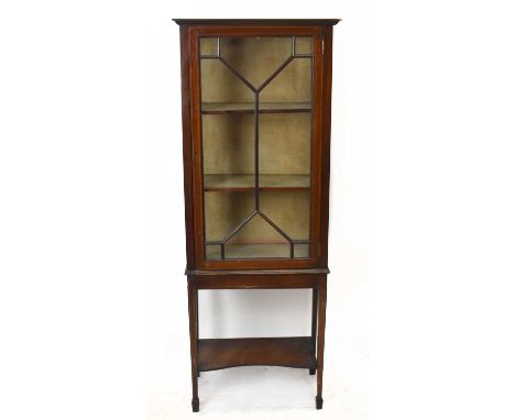 An Edwardian inlaid mahogany display cabinet, the single glazed door enclosing two fixed shelves, on spade legs, height 156cm