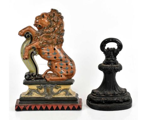 A 19th century cast iron door stop with loop handle, height 24cm, with a further cast iron door stop with painted detailing, 