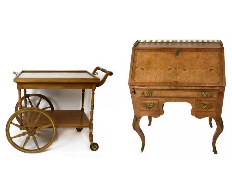 A reproduction French style knee-hole walnut bureau, with brass galleried back above the fall front enclosing cupboard door a