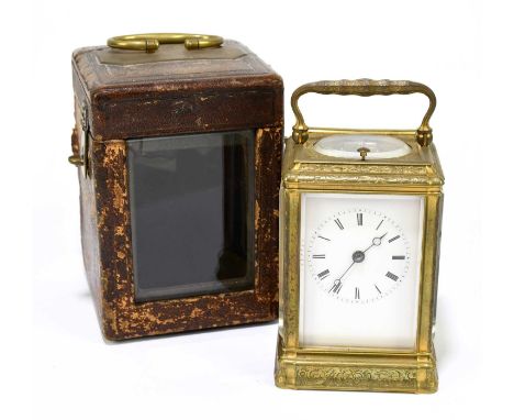 A 19th century French brass cased repeating carriage clock, the enamelled dial set with Roman numerals inside a chased decora