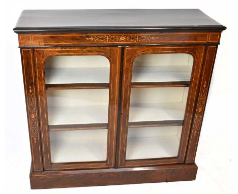 A Victorian inlaid rosewood two door pier cabinet, with two glazed doors enclosing three shelves, on plinth base, height 103c