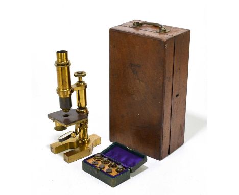 A late 19th century lacquered brass monocular microscope in mahogany case with one spare lens and a small green leather box w