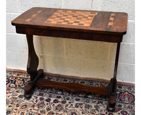 An early Victorian inlaid rosewood games table with chess board top and cribbage markers to the side, on standard end support