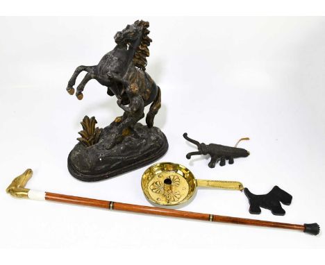 An Arts and Crafts brass chamber stick with embossed open shell detail, length 31cm, together with a bronzed spelter Marly ho