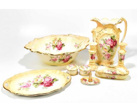 A late Victorian nine piece dressing table set comprising a jug, a bowl, a pair of candlesticks, a toothbrush holder, a ring 