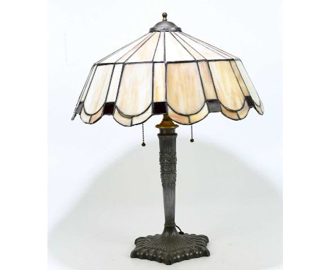 A reproduction Art Nouveau style table lamp with leaded glazed shade above the cast metal base, height 58cm.