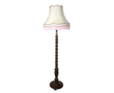 A 1920s oak standard lamp, with spiral turned column on circular base.Condition Report: General light age wear but essentiall