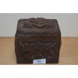 A Chinese hardwood humidor, carved in relief with dragons and birds, measuring 11cm x 12cm x 8cm