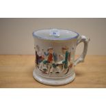 A 19th Century Staffordshire surprise frog mug, decorated in relief with drunkards and measuring