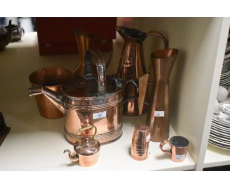 A vintage copper watering can in the design of Dr Christopher Dresser sold alongside a copper flower pot, three copper servin