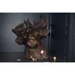 A 20th Century painted plaster bust of a stag, with some breakages and measuring 34cm high