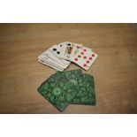 A bundle of vintage playing cards, the reverse printed with a Swastika design