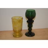 A Bohemian green etched glass wine glass, measuring 19cm high, and a 19th Century Bohemian amber