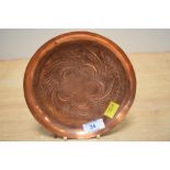 A Keswick School of Industrial Arts circular copper dish with repousse decoration of scrolling