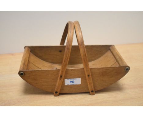 A stained oak ornamental miniature trug with wrap around handles, measuring 25cm long