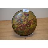 A mid-20th Century Disney themed tin, depicting Donald and Daisy Duck, measuring 16cm in diameter