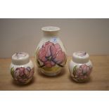 A William Moorcroft ovoid shaped vase, decorated in the Hibiscus pattern against a cream ground