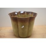 A 20th Century German lobed jardiniere, covered in a dripped green/brown glaze with maker's mark