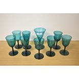 A selection of early 19th Century deep green coloured glasses, the largest measures 14cm high