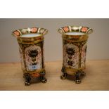 A pair of Royal Crown Derby footed vases, decorated in the Old Imari pattern with flared rims and