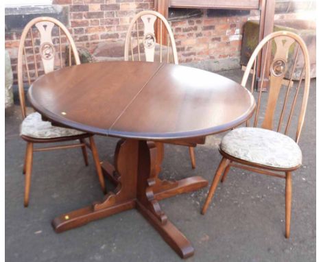 "Ercol" extendable dining table and three Ercol dining chairs with a swan design Condition report: see terms and conditions.