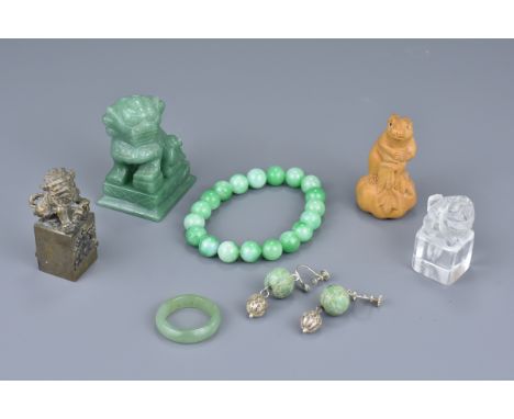 A rock crystal and white metal seal, a carved wooden netsuke of a rabbit, a jade ring, a jade beaded bracelet, pair of green 