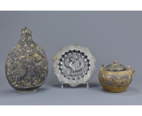 Three Chinese Liao Dynasty Style white metal items. To include a flask carved in relief, a gilt white metal teapot (missing h