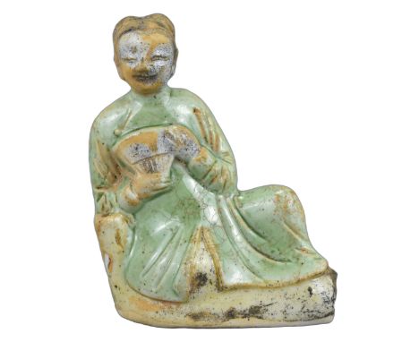 A Fine Small Chinese Porcelain Figure of a Reclining Lady – Kangxi. An attractive small figure of a reclining lady holding a 