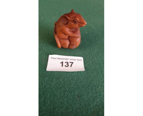 Carved fruit wood netsuke of a mouse signed to base. 