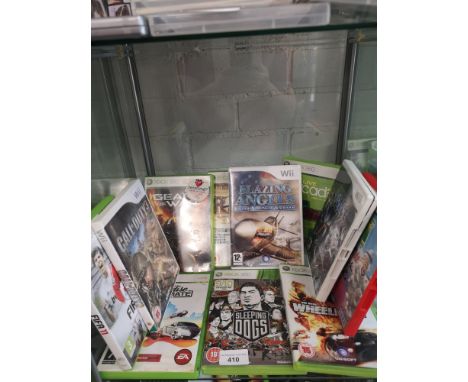 Shelf of xbox 360 &amp; ninetendo wii games. 