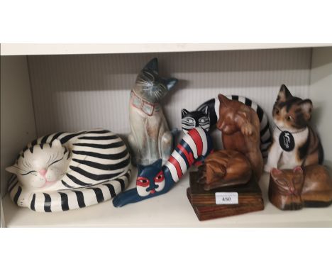 Shelf of collectable cat figures. 