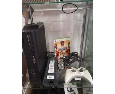 Xbox 360 console with controller and game. 