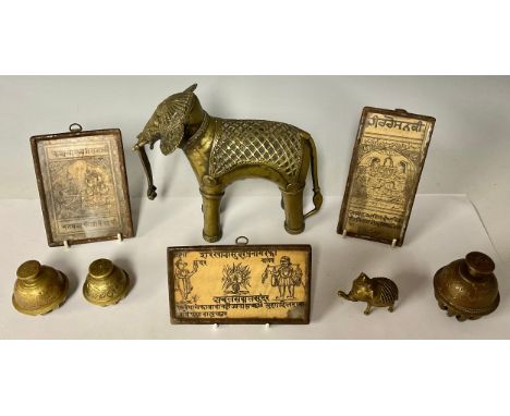 A 19th century brass Indian elephant, 17cm high; another similar, smaller; three brass Indian claw elephant bells, chased wit